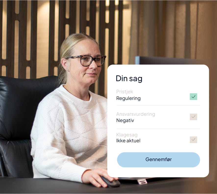 a woman sitting at a desk with a computer mouse