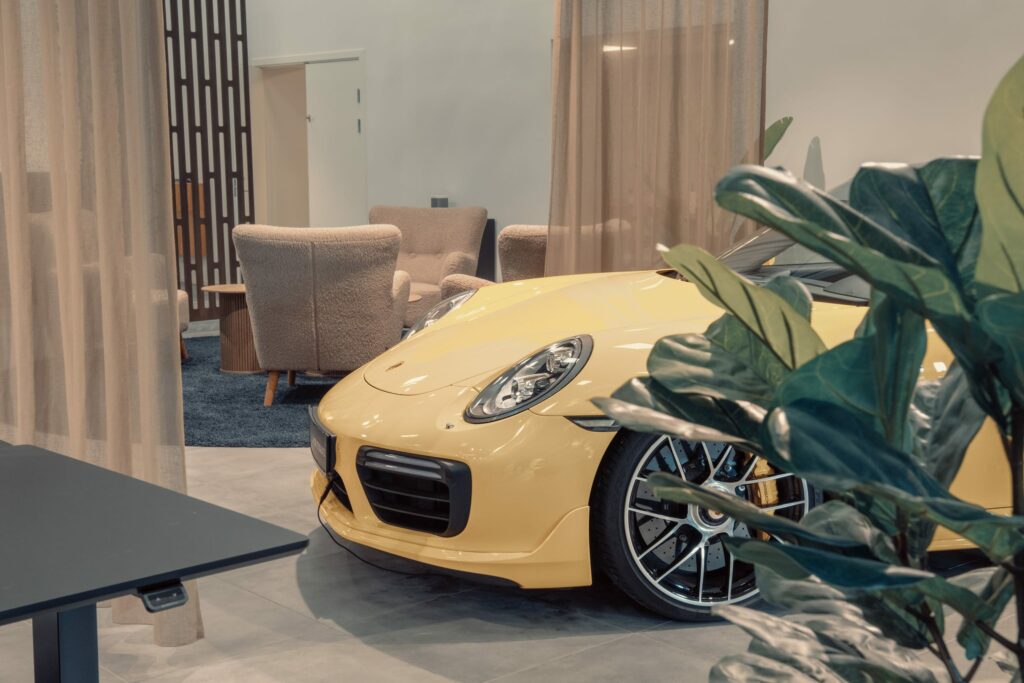 a yellow sports car in a room